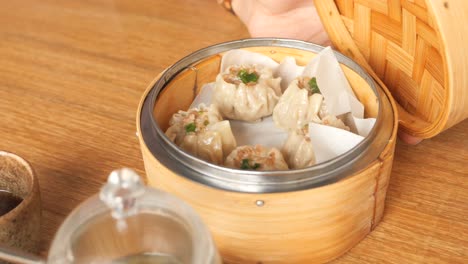 delicious steamed shumai dumplings in a bamboo steamer