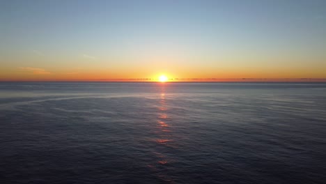 sunrise over sea with lighthouse