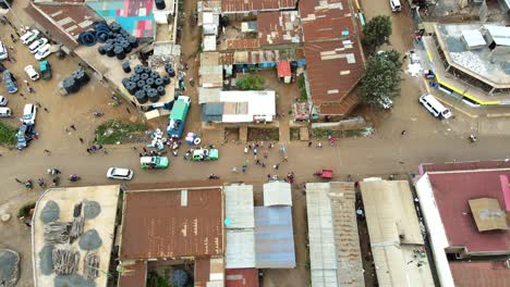 aerial view of cars and people at a open air market, in africa - reverse, drone shot