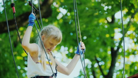 A-Brave-Child-Walks-Along-A-Tightrope-Between-Tall-Trees-Active-Childhood-And-Fun