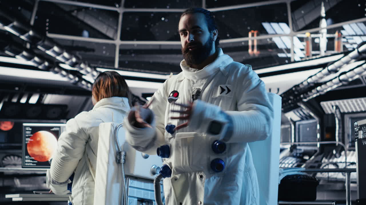 Astronaut waves hand during videocall with Earth command center