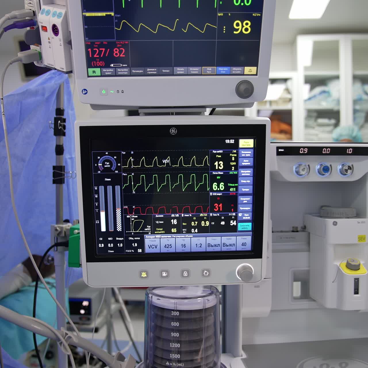 Advanced technological equipment switched on and working during operation. Numerous apparatuses involved in operation. Screens depicting patient's condition. Close up