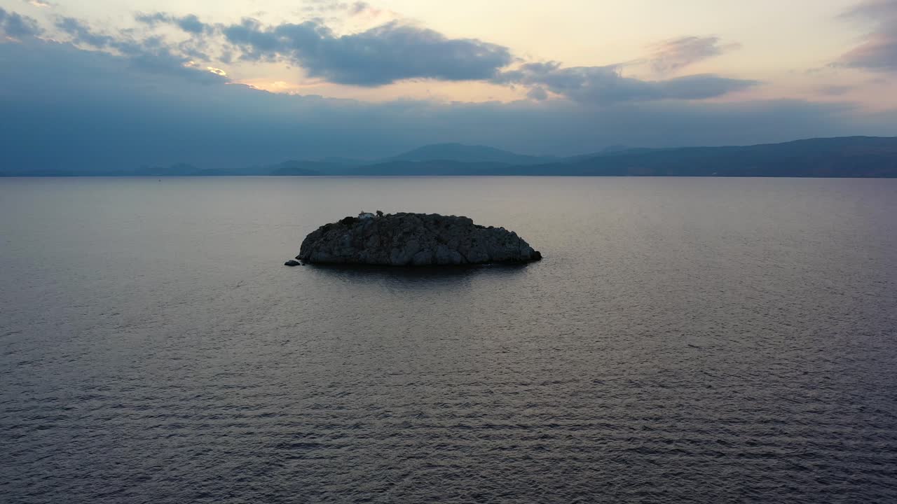 A small island in front of Vlychos Plakes Beach in Hydra Island, Greece
