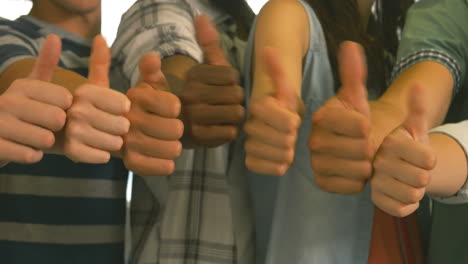 students showing thumbs up together