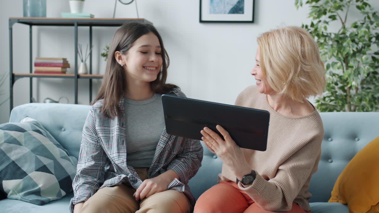 Grandmother and granddaughter using a tablet together