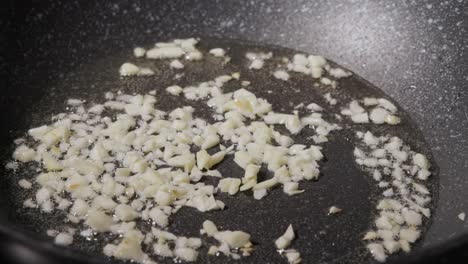 frying garlic in a pan - close up