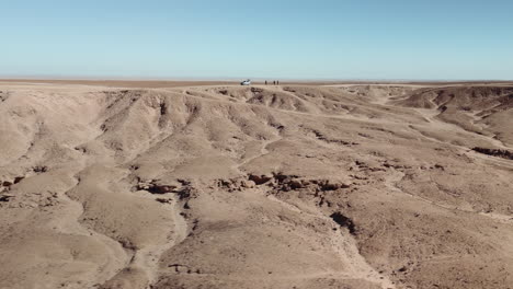 desert landscape with vehicle and people