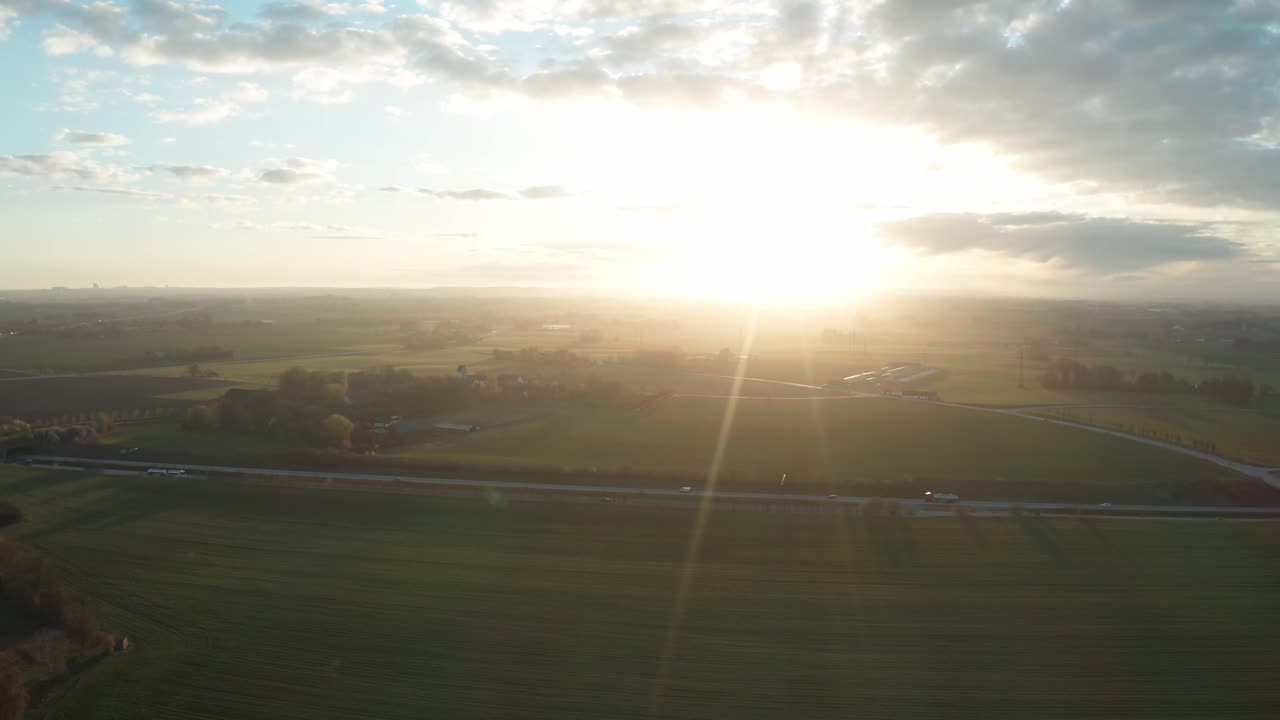 Backlit drone shot during spring sunrise in Southern Sweden