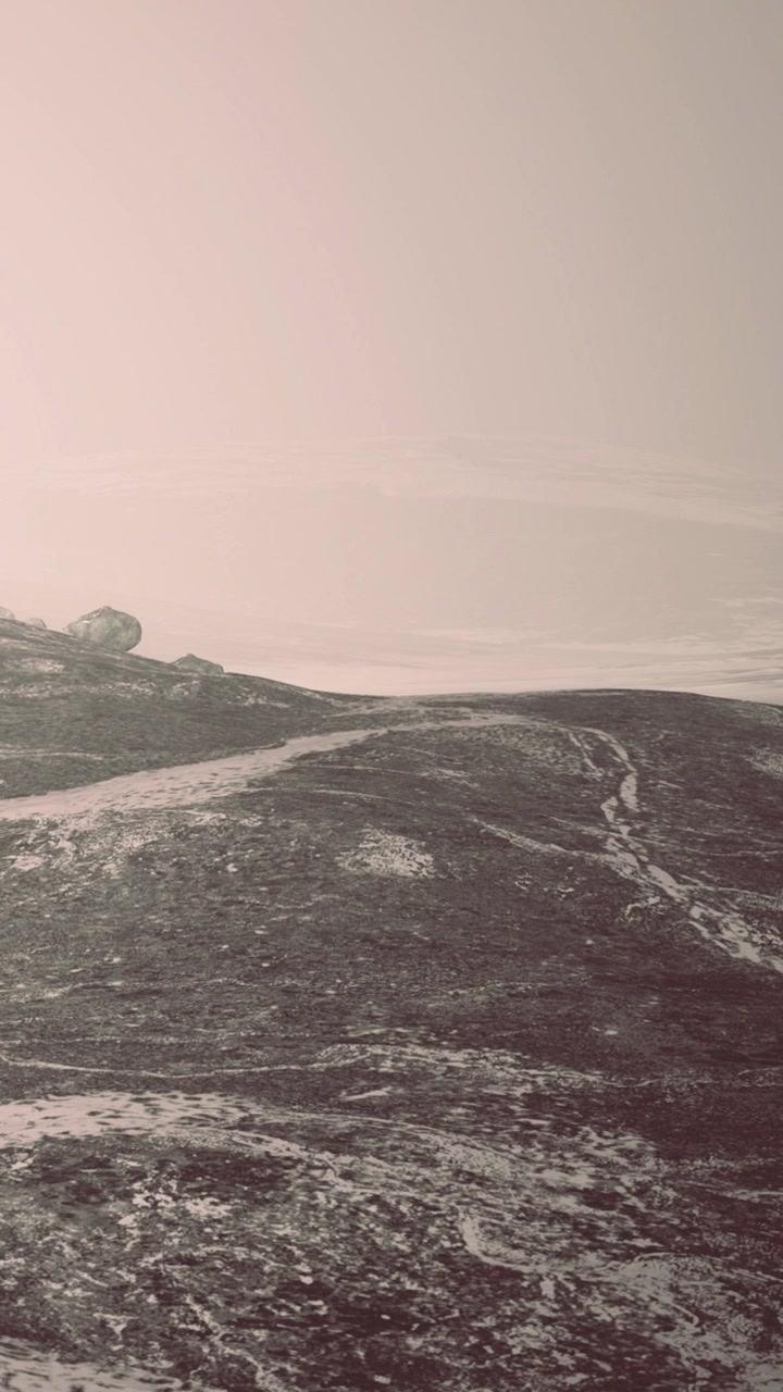 Path winding through rocky landscape near ocean under cloudy sky