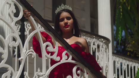 Dentro-De-Los-Desgastados-Muros-De-Un-Castillo-Caribeño,-Una-Joven-Encanta-Con-Su-Vibrante-Vestido-Rojo