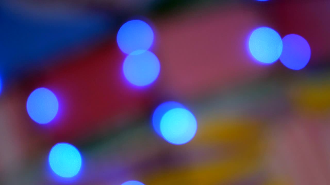 Blurred colorful lights. Red, green, yellow, orange, blue defocused glittering bokeh festive background.