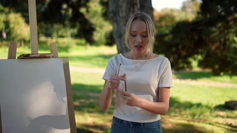 young woman painting outdoors