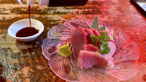 sashimi served with soy sauce and garnish