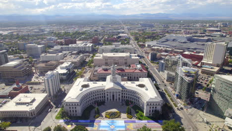 Aerial-Drone-flyover-revealing-Denver-city-council-building-in-civic-center-park-Downtown-Denver,-Colorado,USA