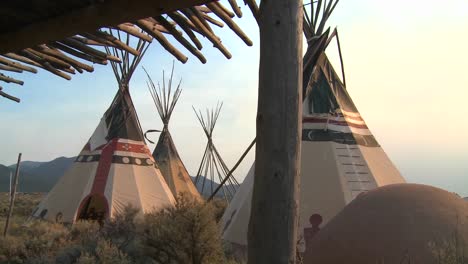 indian teepees stand in a native american encampment