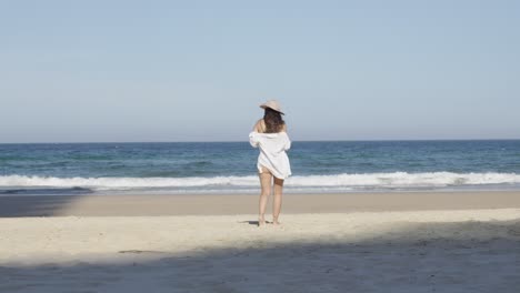 girl at the beach, beautiful young woman beachwear walking toward ocean