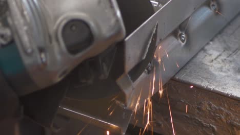 impressive spark shower of angular metal cutting. a metal worker is cleaning the rusty surface of a steel sheet. slow motion