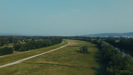 aerial riverbank view near zagreb with greenery and distant mountains