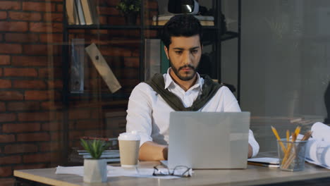 Good-Looking-Arabian-Businessman-Sitting-At-The-Table-And-Working-On-The-Laptop-Computer,-Then-Drinks-Coffee