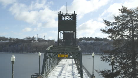 Aerial-orbit-establisher-historic-lift-bridge-in-Stillwater-Minnesota,-winter