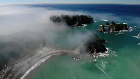 cinematic aerial of james island pacific ocean, washington with morning foggy seascape