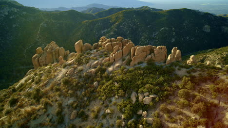 drone shot flying towards unique hoodoo rock formations on southwestern desert mountain