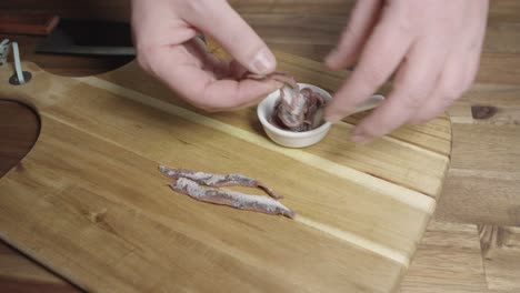 chef preparing anchovies for cutting