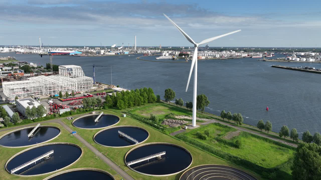 Water purification, waste water, treatment, cleaning of water. Next to Major river, Meuse, Rotterdam, The Netherlands. Aerial.