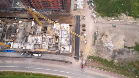 Aerial-top-down-shot-of-construction-site-with-crane-in-city-center-of-Gdansk,-Poland