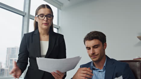 upset workers check documents in office. two colleagues talking analysing data