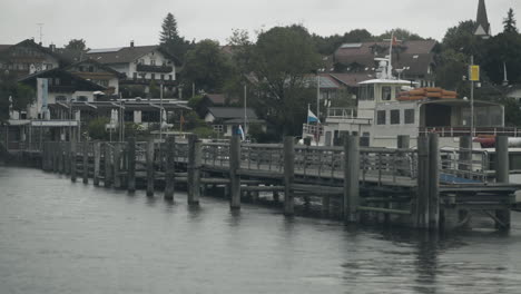 handheld shot of a boat waiting for passengers to carry tothe next port at the lake chiemsee