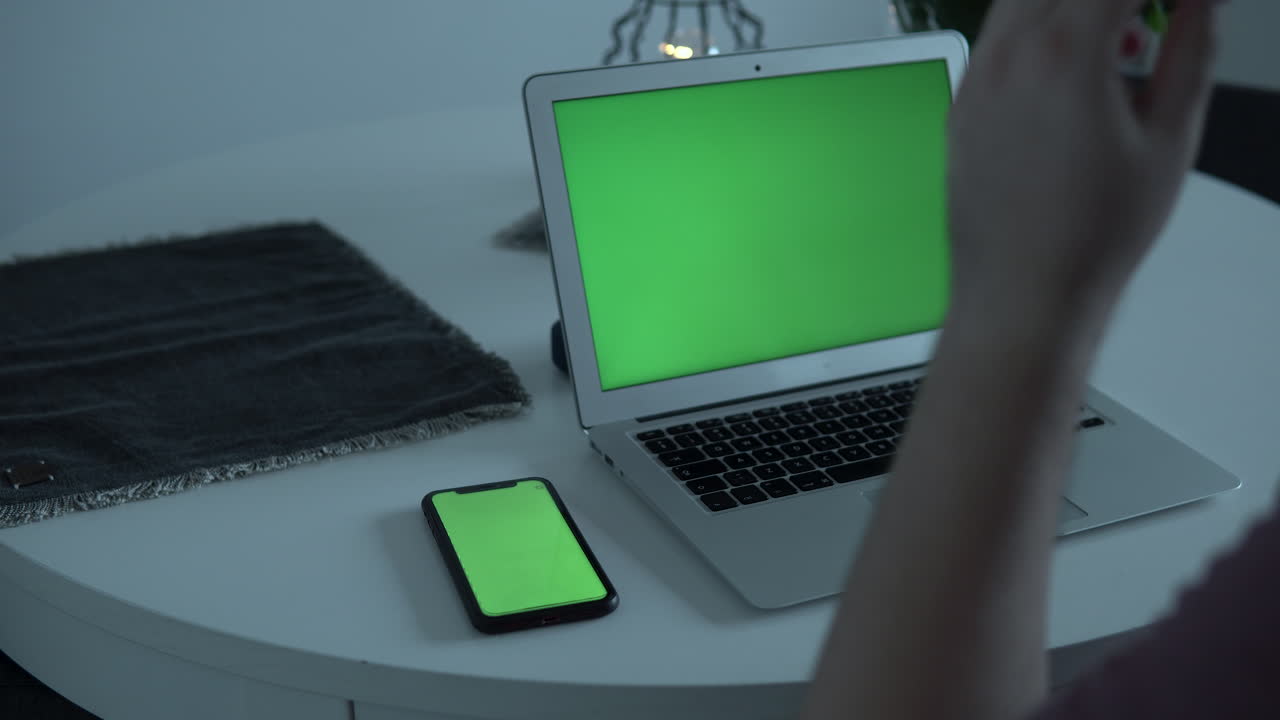 Man take glasses form white table and start write on laptop keyboard, home office during cornavirus, close up