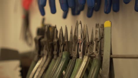 detail of work room full of pliers, tweezers, splitters, files and other tools in slow motion