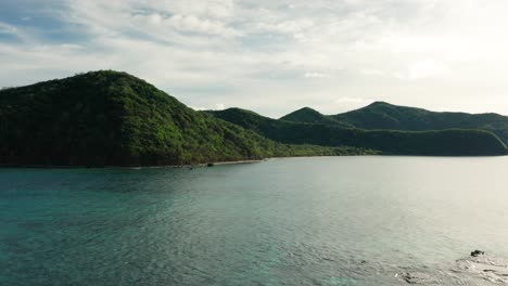 Perfect-morning-light-hits-lush-green-hills-of-Naviti-Island-in-Yasawas,-Fiji