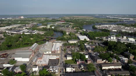 Aerial-view-over-suburbs,-towards-the-Christina-river-and-Brandywine-creek,-summer-in-Wilmington,-Delaware,-USA