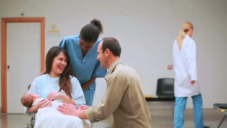 Nurse-with-a-mother-and-a-father-with-their-baby-on-a-wheelchair