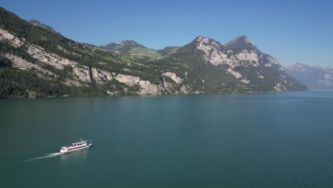 ferry cruising down blue-green waters with a scenic mountain backdrop