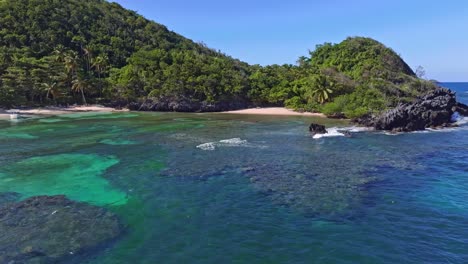 Aerial-drone-view-of-Playa-Ermitano-beach-and-blue-sea-water-in-Dominican-Republic