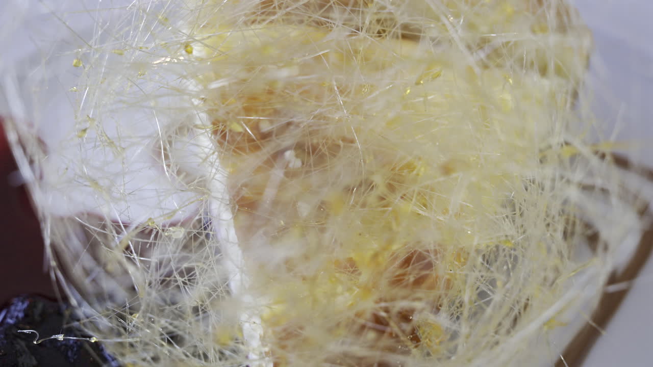 Close up of a piece of cheesecake with blueberry sauce on a white plate