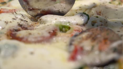 Closeup-sliding-shot-of-slicing-pizza