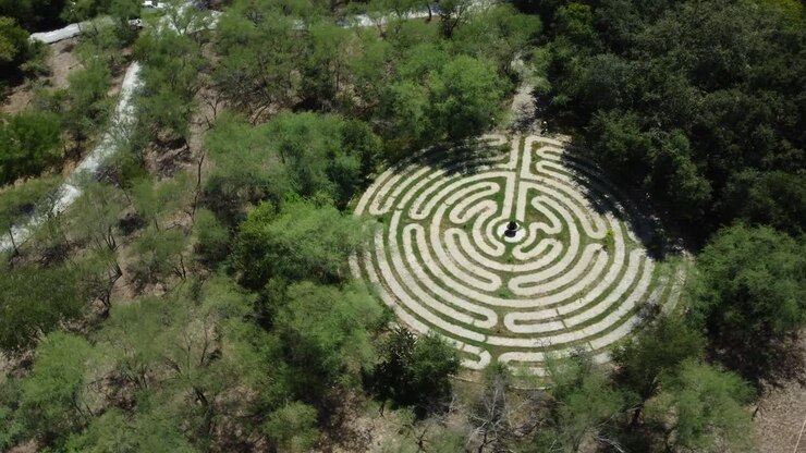 Aerial establishing shot of a geometrical stone maze puzzle in the countryside