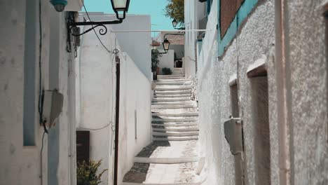 clip of a small traditional pathway among houses in a greek island