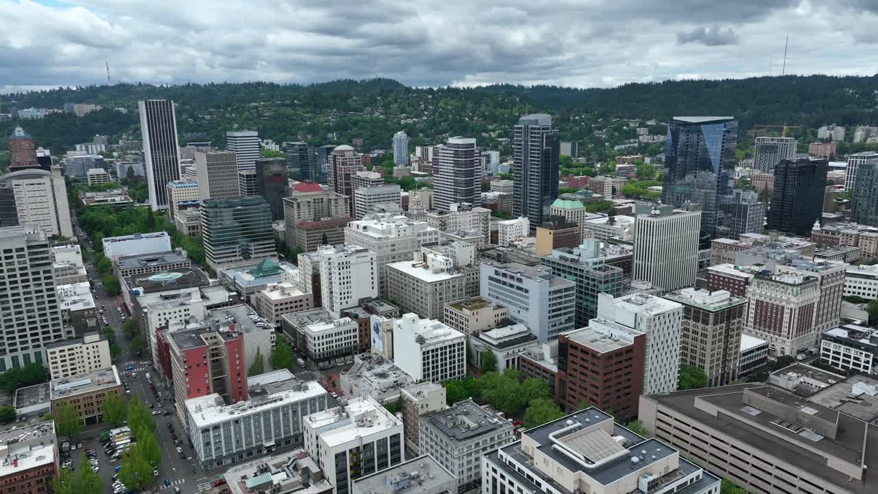 High Altitude Aerial Drone Pan of Downtown Portland Oregon skyline and buildings on a cloudy summer day