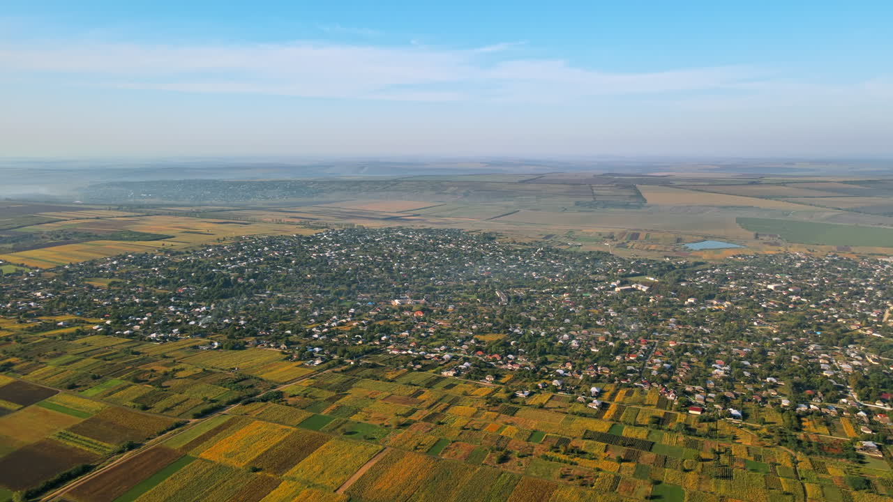 Aerial drone view of village in Moldova. Residential buildings, greenery, fields around