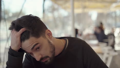 nervous young man working in cafe