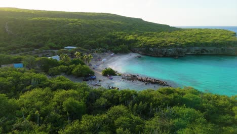 Aerial-parallax-around-crystal-clear-water-cove-of-Daaibooi-beach-Curacao