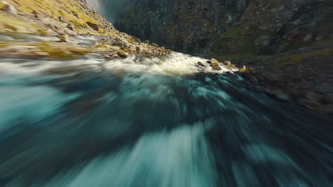 fpv drone flying towards a massive waterfall