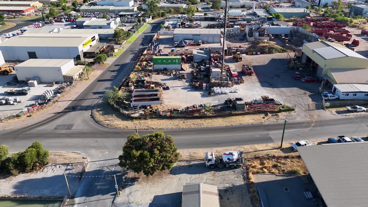 Forward moving drone shot capturing industrial area with loades and trucks parked for transportation. Industry view.