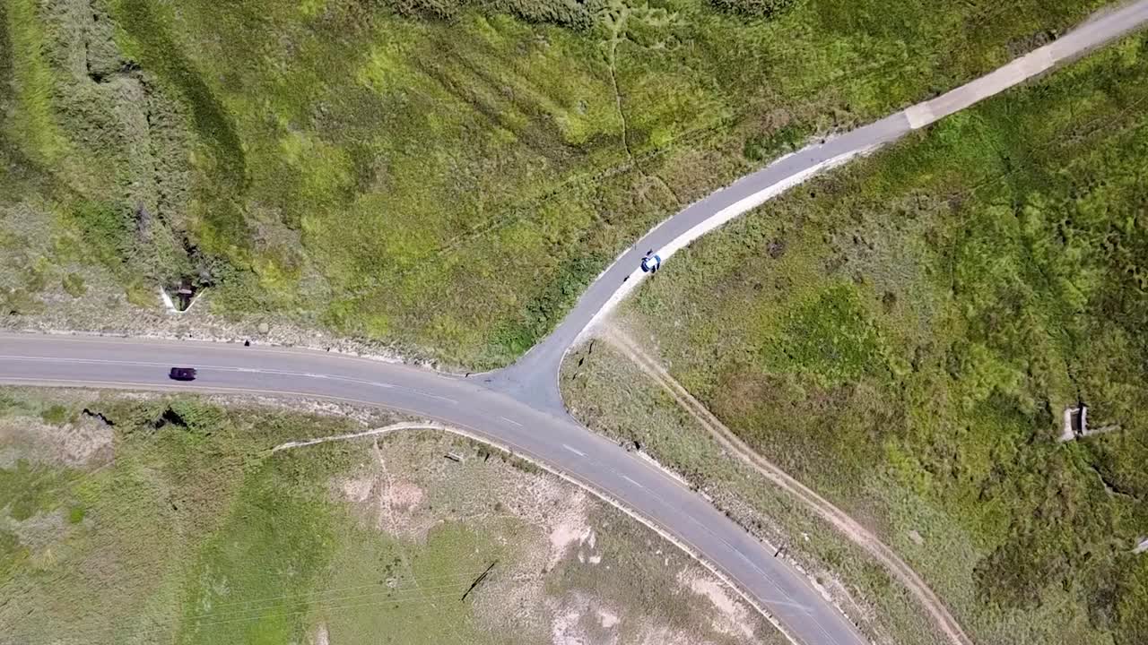 Dynamic rotating birdseye view of a road turnoff in a national park, showcasing scenic beauty. Perfect for travel, nature, and adventure projects
