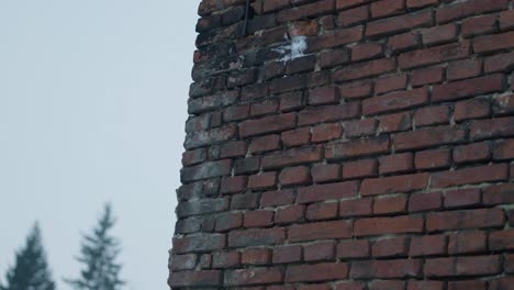 slowmotion snowballs hiting and splashing a red brick stone wall